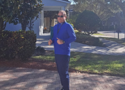 Man standing in front of home smiling